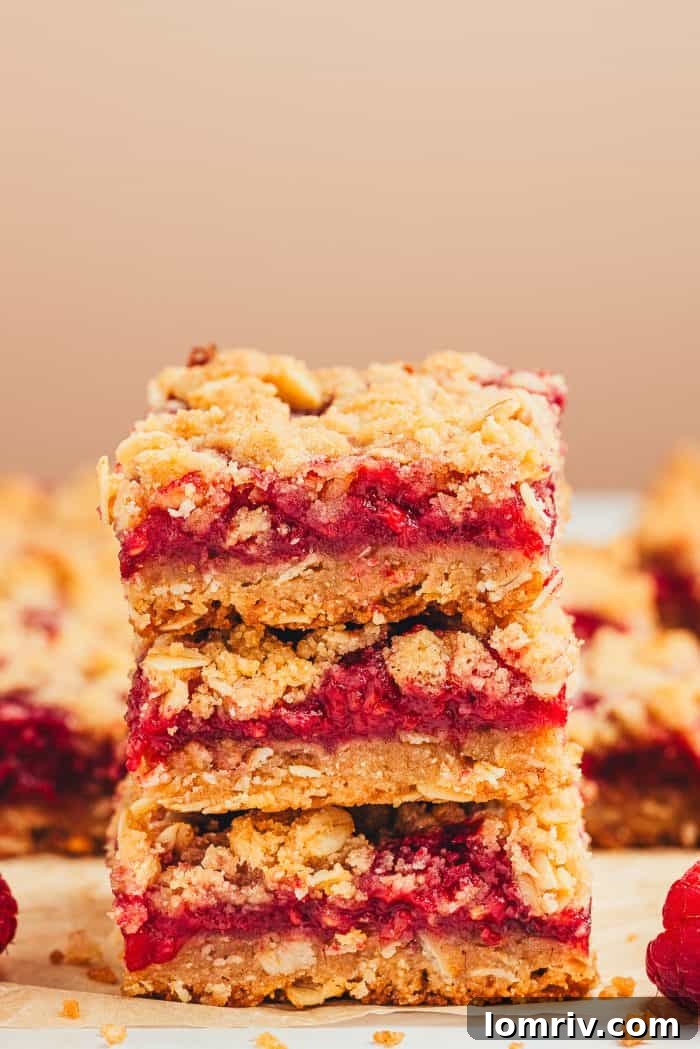A stack of three raspberry crumble bars.