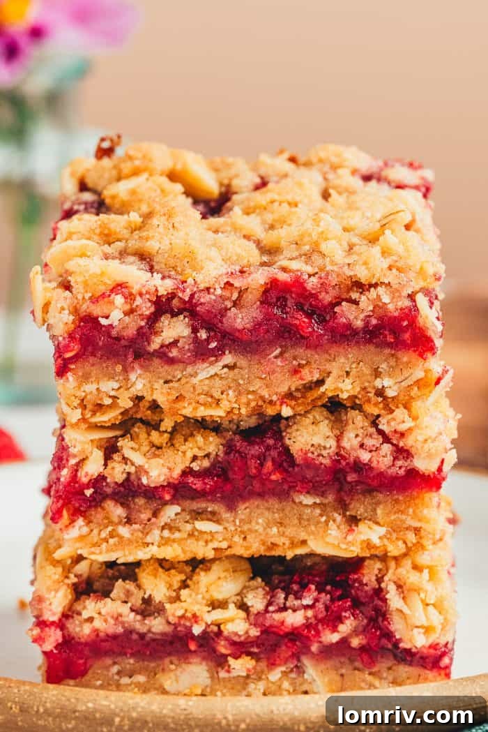 A stack of three raspberry crumble bars.