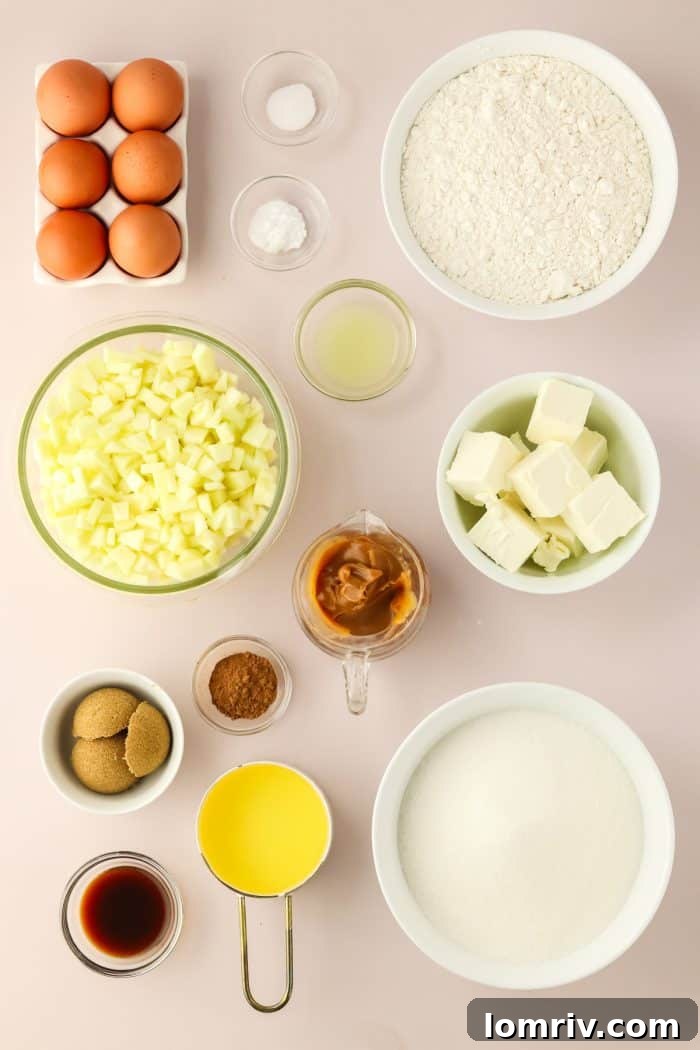 Bowls of perfectly measured ingredients for the Caramel Apple Bundt Cake, including flour, cinnamon, apples, and sugar, neatly arranged for baking.