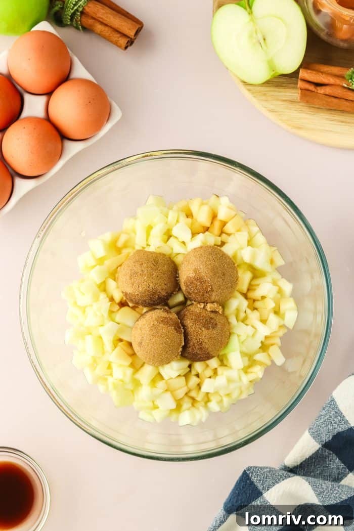 Diced Granny Smith apples glistening with lemon juice and generously coated in rich brown sugar, ready to be incorporated into the cake batter.