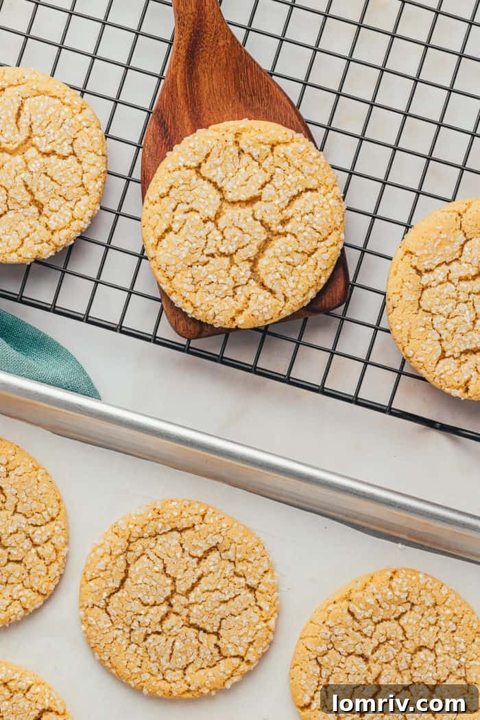 The finished brown butter sugar cookies neatly arranged on a cooling rack, glistening with their sugary tops.