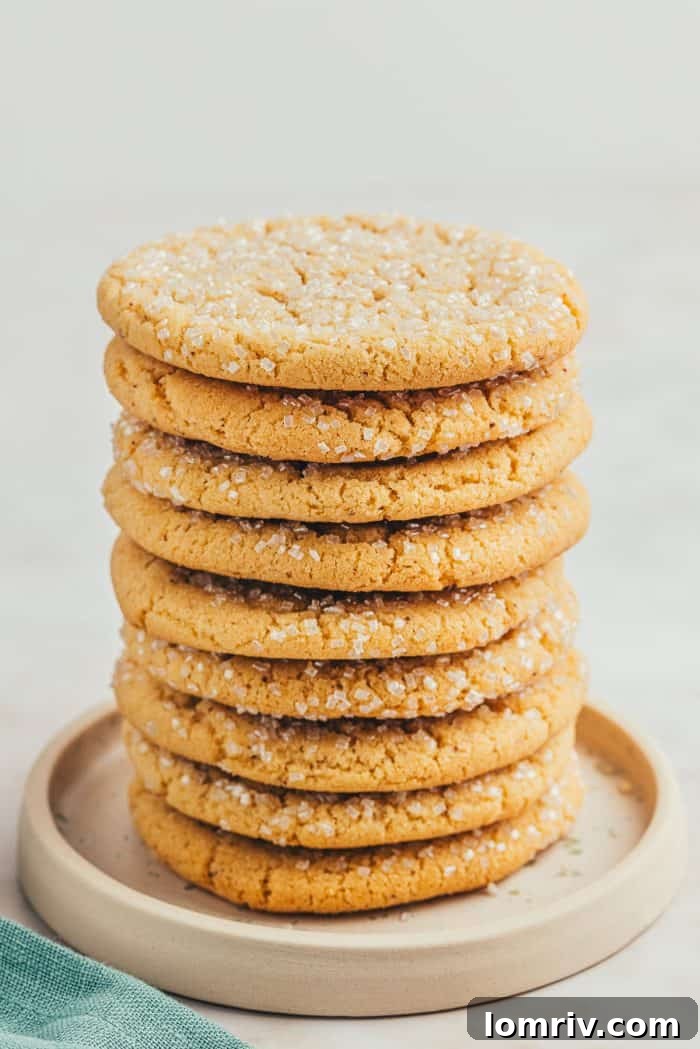 A perfectly stacked tower of browned butter sugar cookies, highlighting their golden-brown color.