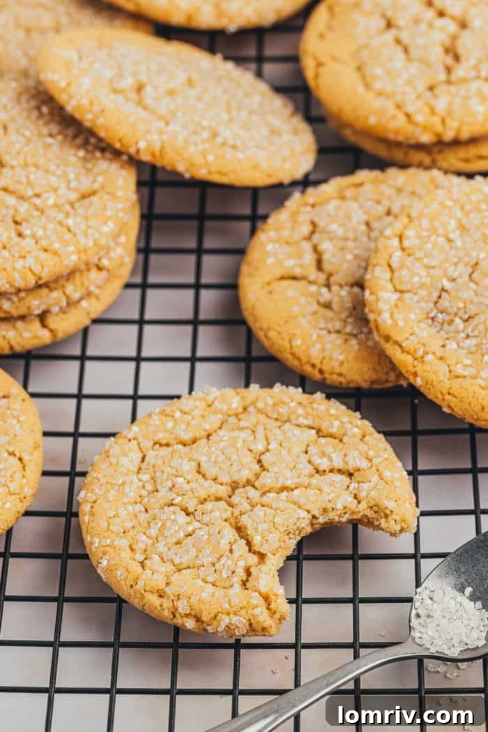 A cooling rack neatly organized with various browned butter sugar cookies, perfectly baked and cooling down.
