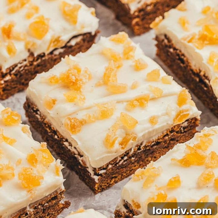 The gingerbread bars with frosting and candied ginger cut into squares.