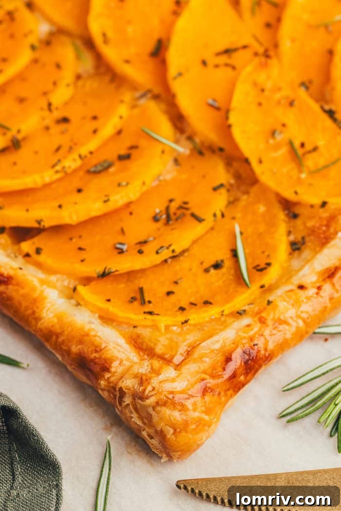 A close-up view of the rich and colorful butternut squash tart filling, showcasing its layers.