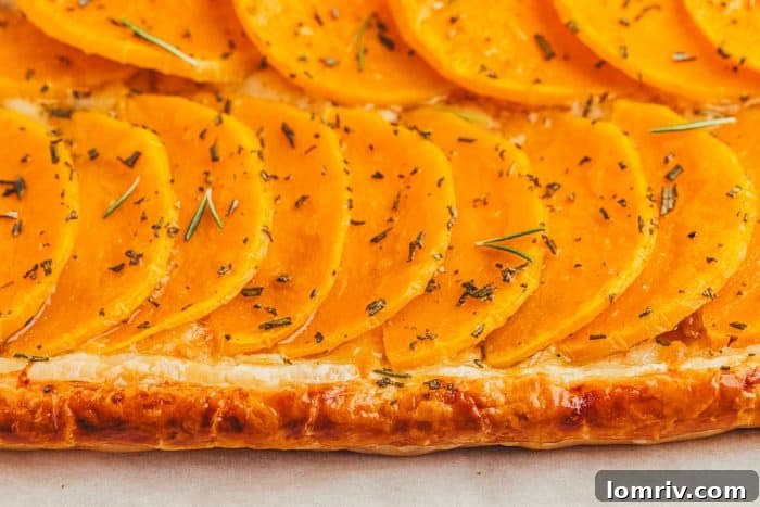 A vibrant close-up of the prepared butternut squash tart filling, ready for baking.