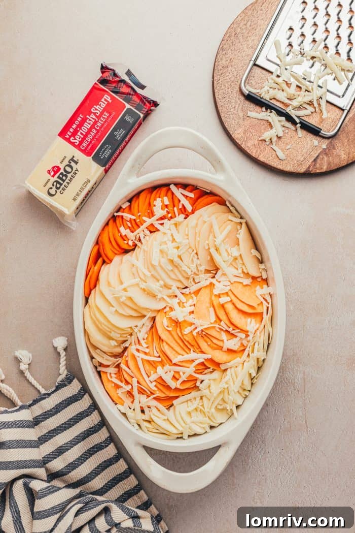Half of the shredded cheddar cheese sprinkled over the vegetables