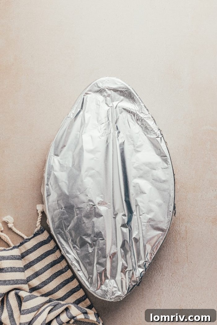 A baking dish covered with aluminium foil, ready for the oven.