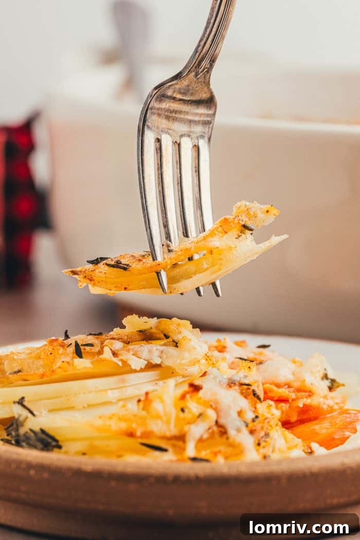 A large serving of root vegetable gratin in a white baking dish.