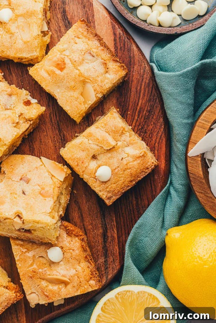 Beautifully sliced lemon blondies adorned with scattered white chocolate chips, ready to be enjoyed.
