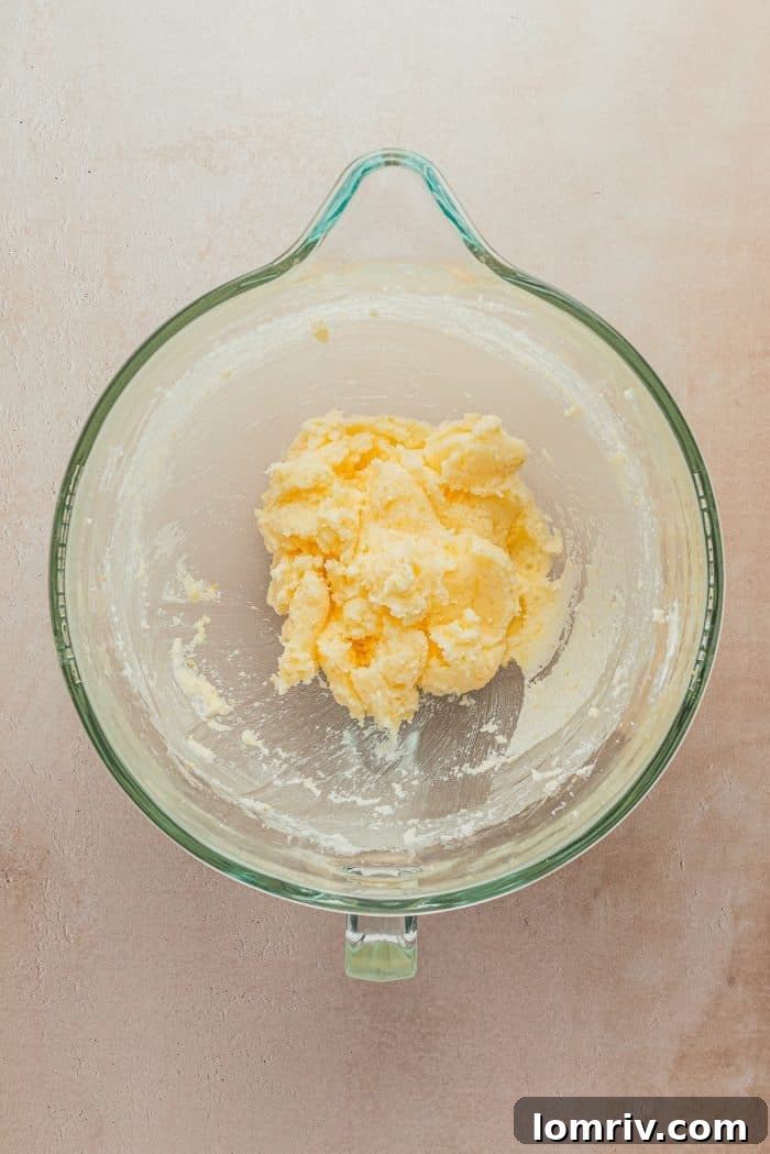 Softened unsalted butter in a clear glass bowl, ready for mixing.