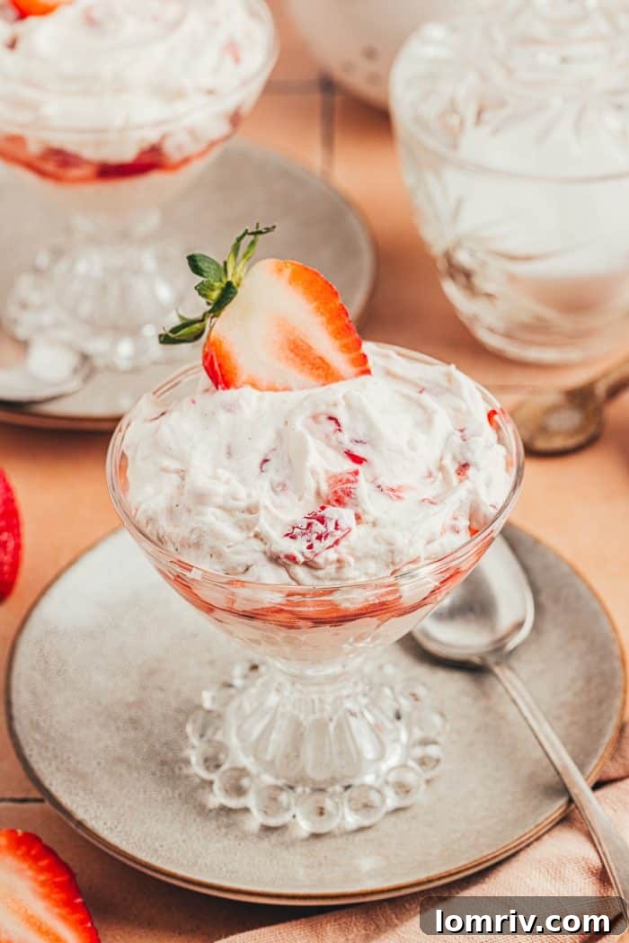 A glass parfait dish with homemade strawberry fool.