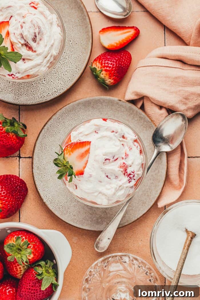 A glass parfait dish with homemade strawberry fool.
