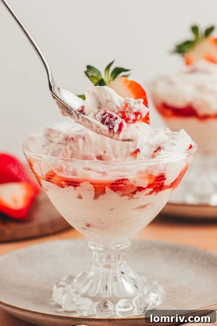 A glass parfait dish with homemade strawberry fool.