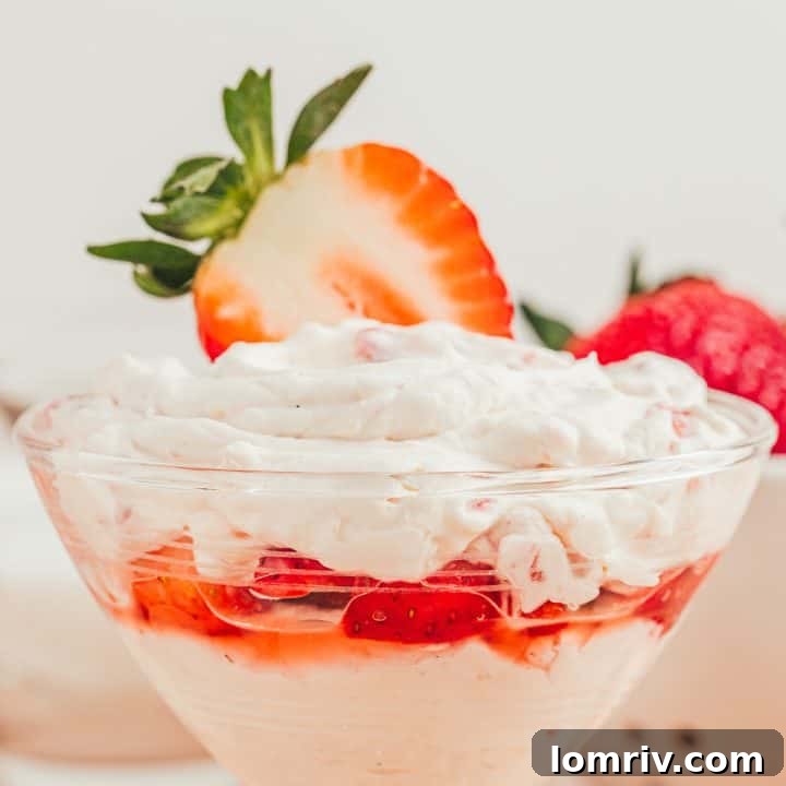 A glass parfait dish with strawberry mascarpone fool.