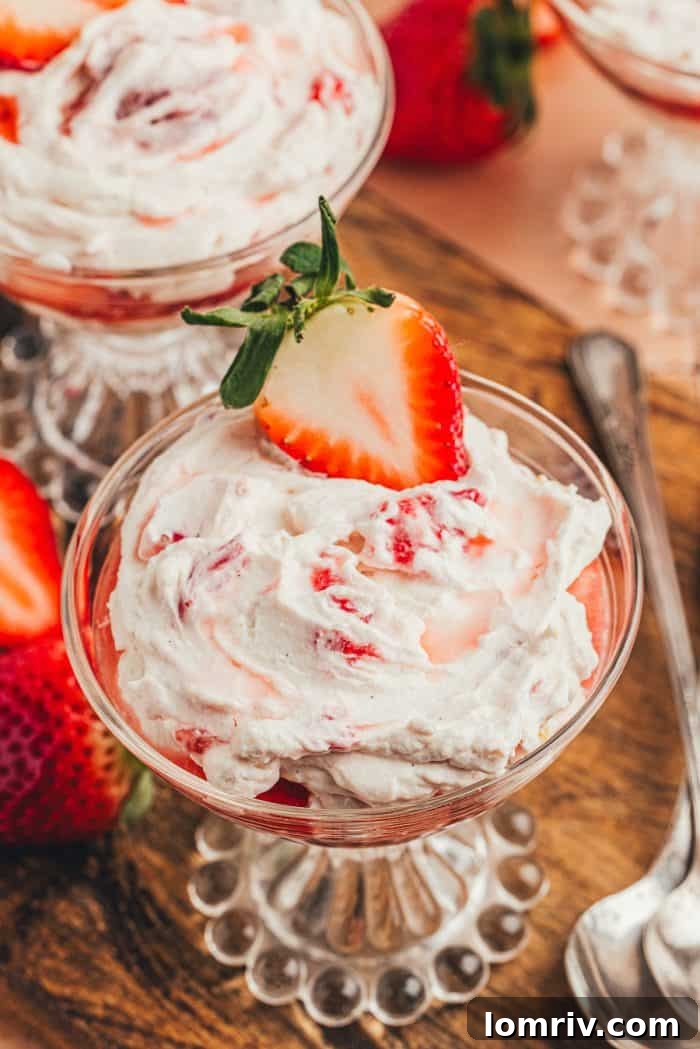 A glass parfait dish with homemade strawberry fool.