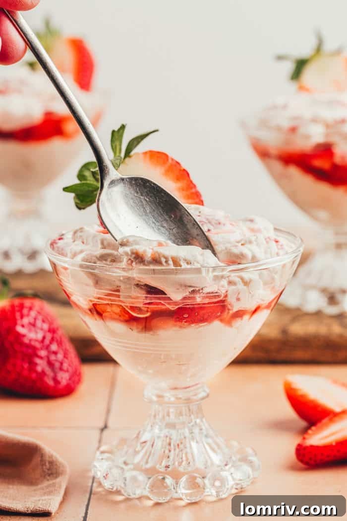 A glass parfait dish with homemade strawberry fool.