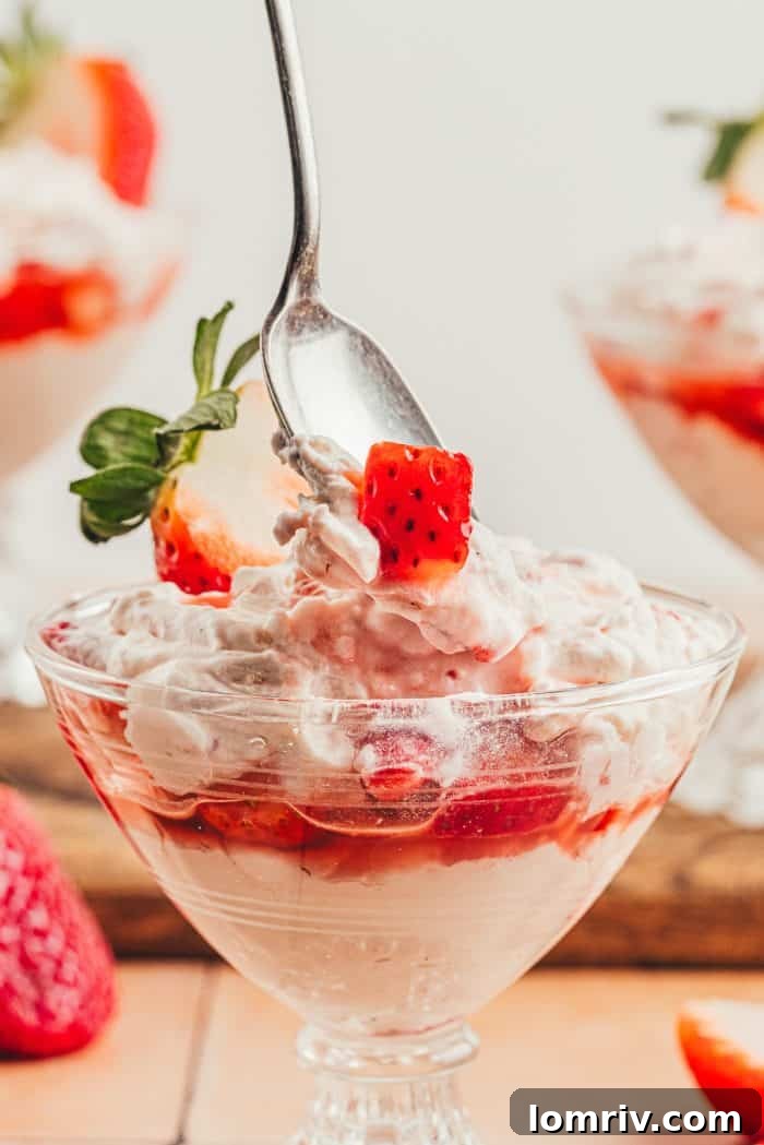 A glass parfait dish with homemade strawberry fool.