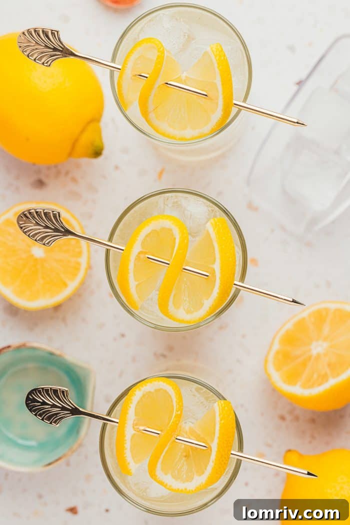 Three elegant glasses of lemon elderflower mocktail, perfectly garnished and ready to be enjoyed.