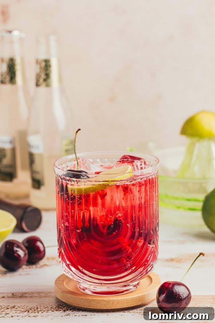 A virgin cherry Moscow mule garnished with lime slices and cherries.