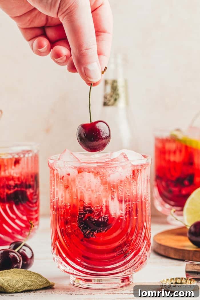 A virgin cherry Moscow mule being garnished with a cherry.