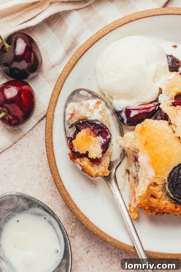 A plate with a scoop of browned butter cherry cobbler.