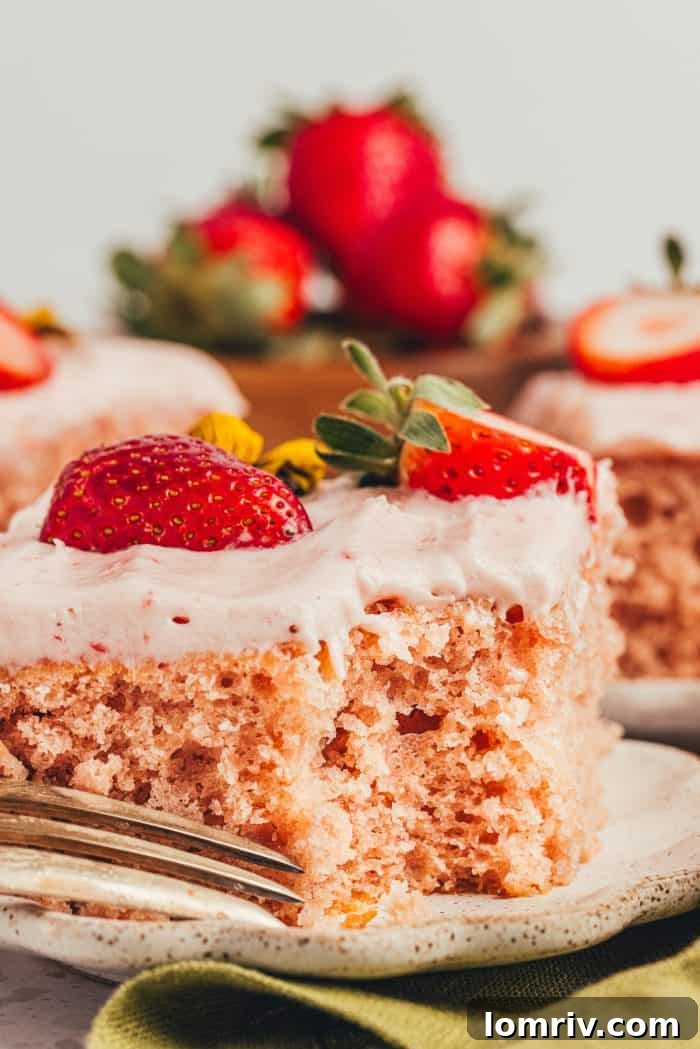 Another mouth-watering slice of strawberry sheet cake on a plate, enticing with its perfect texture