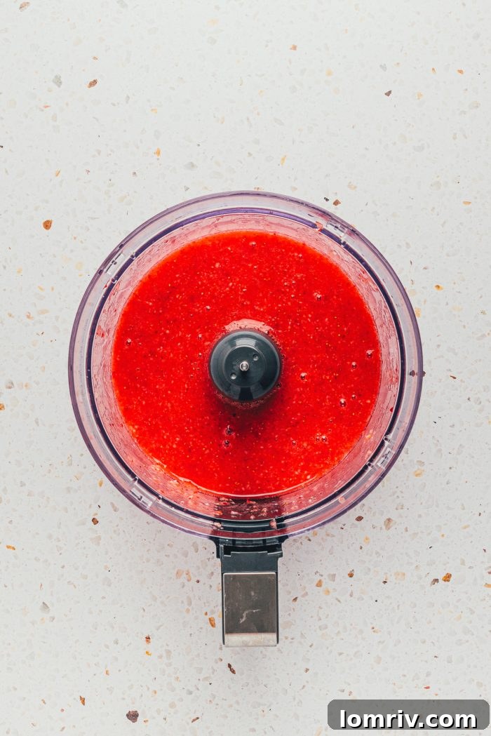Fresh strawberries pureed in a food processor, the first step to creating the flavorful reduction