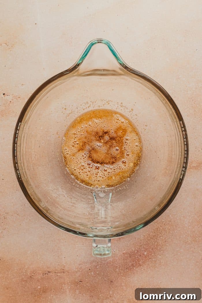A glass mixing bowl with brown butter.