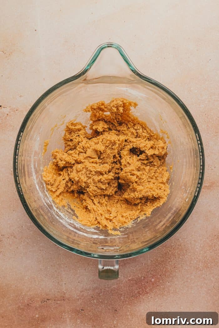The flour mixture added to the glass mixing bowl.