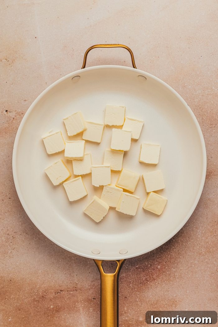 Cubed butter added to the skillet.