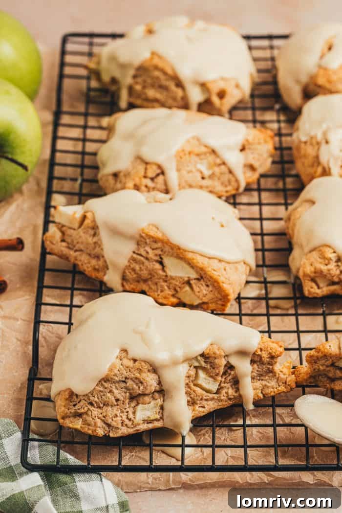 Apple cinnamon scones on a black cooling rack.