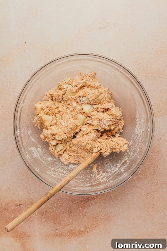The dough for apple cinnamon scones in a glass mixing bowl.