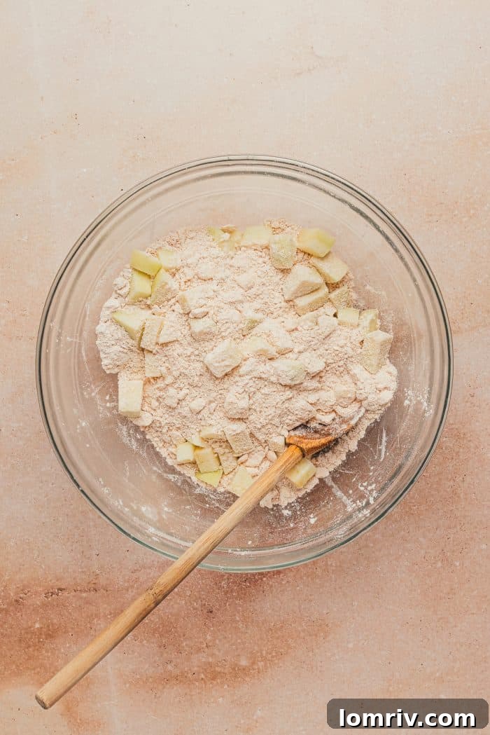 Diced apples added to the flour mixture.