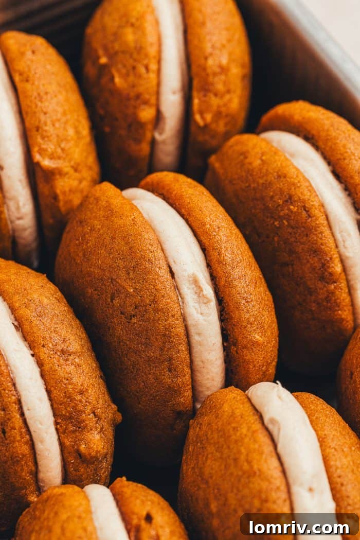 Close-up view of a perfectly baked pumpkin whoopie pie, showcasing its soft texture and inviting color.