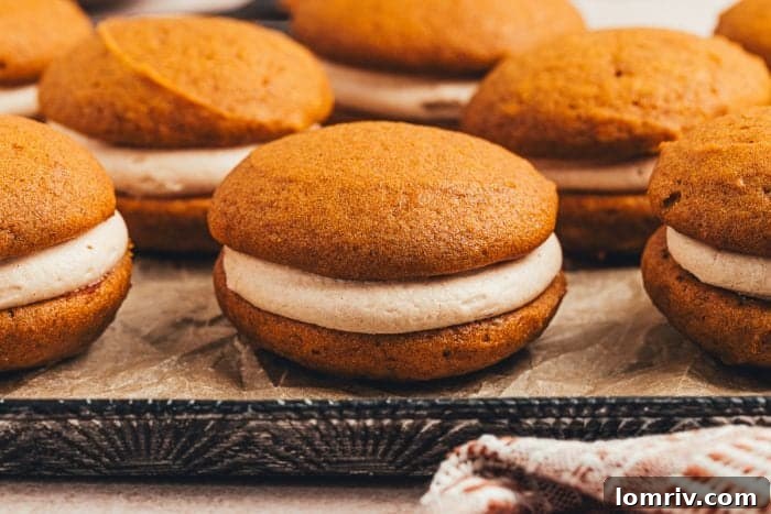 A delightful array of pumpkin spice whoopie pies artfully arranged on a serving tray, perfect for any gathering.