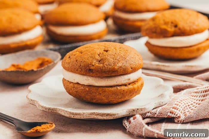 A single, inviting pumpkin whoopie pie showcased on a white plate, perfect for a cozy autumn treat.