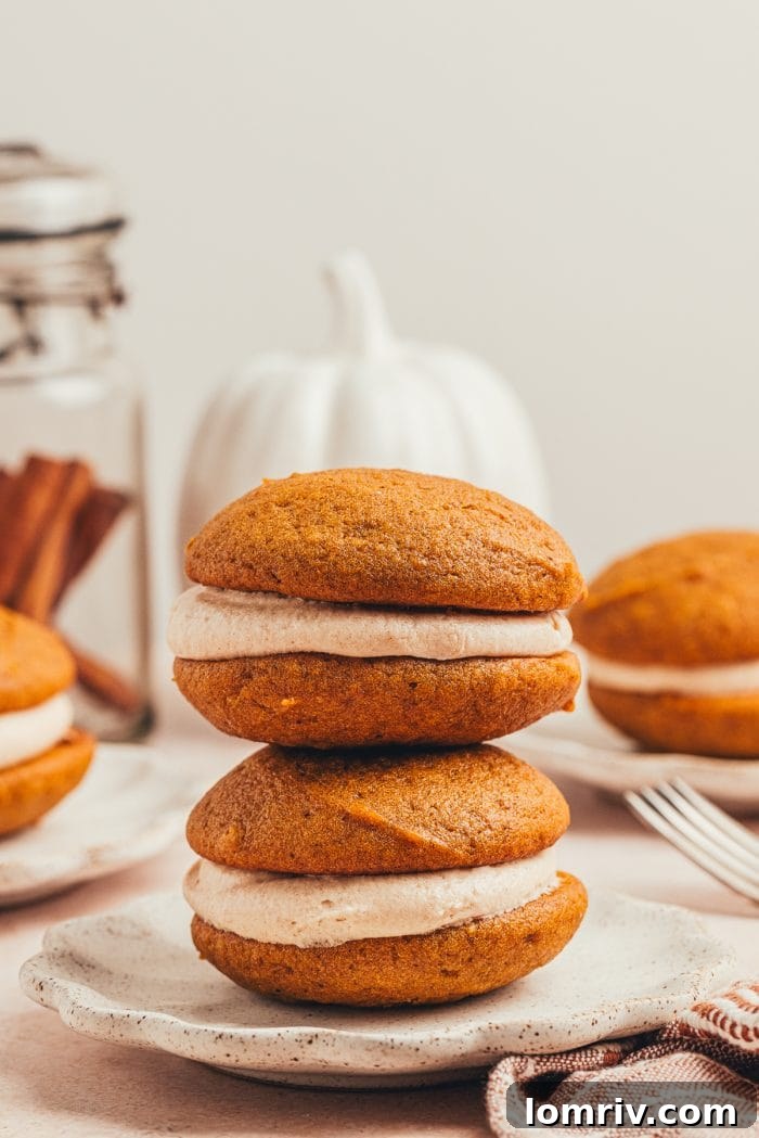 A beautiful stack of freshly made pumpkin whoopie pies, ready to be enjoyed.