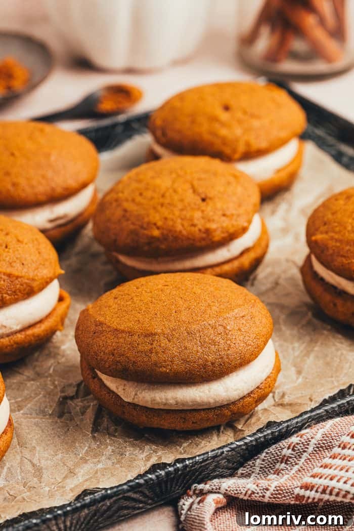 A delightful variety of pumpkin spice whoopie pies arranged on a serving tray, showcasing their perfect round shapes.