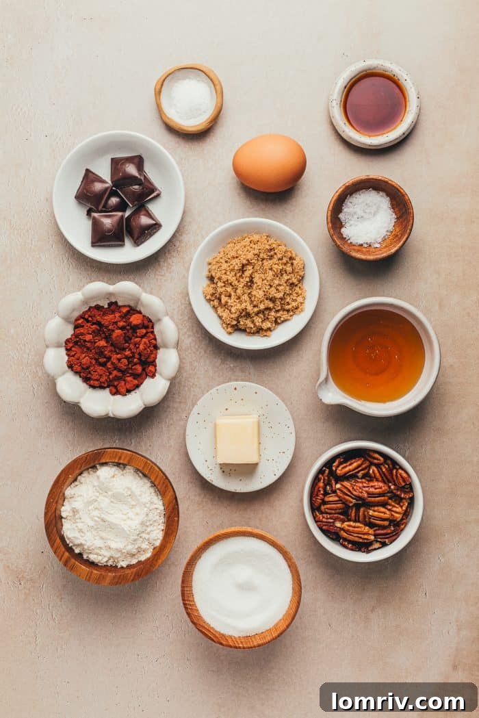 A variety of bowls and plates with the ingredients to make pecan pie brownies.