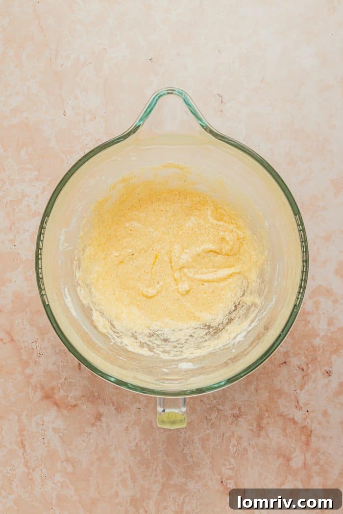 Softened butter, a key ingredient for the frangipane, is placed in a mixing bowl, ready to be creamed.