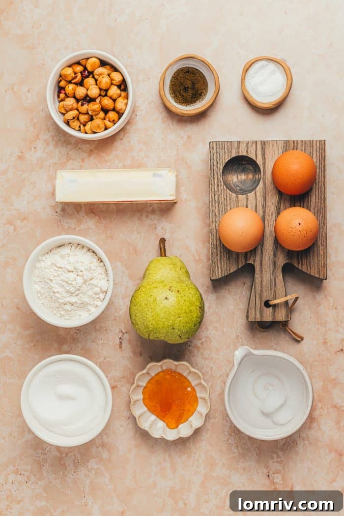 A flat lay photograph displaying all the fresh, high-quality ingredients needed to create a Hazelnut Frangipane Pear Tart, neatly arranged on a counter.