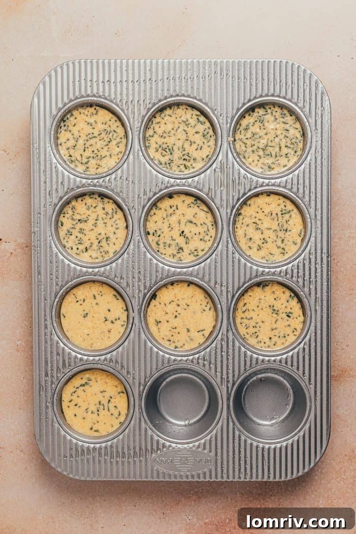 The popover batter poured into a cupcake pan.