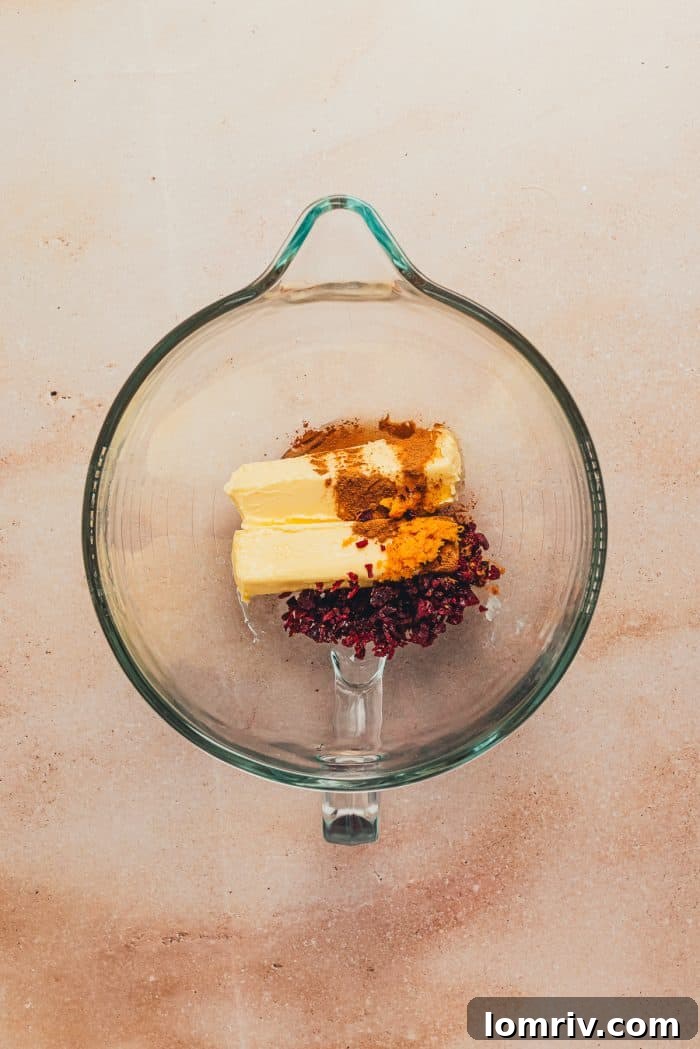 Butter, cranberry, and orange zest added to a large bowl.