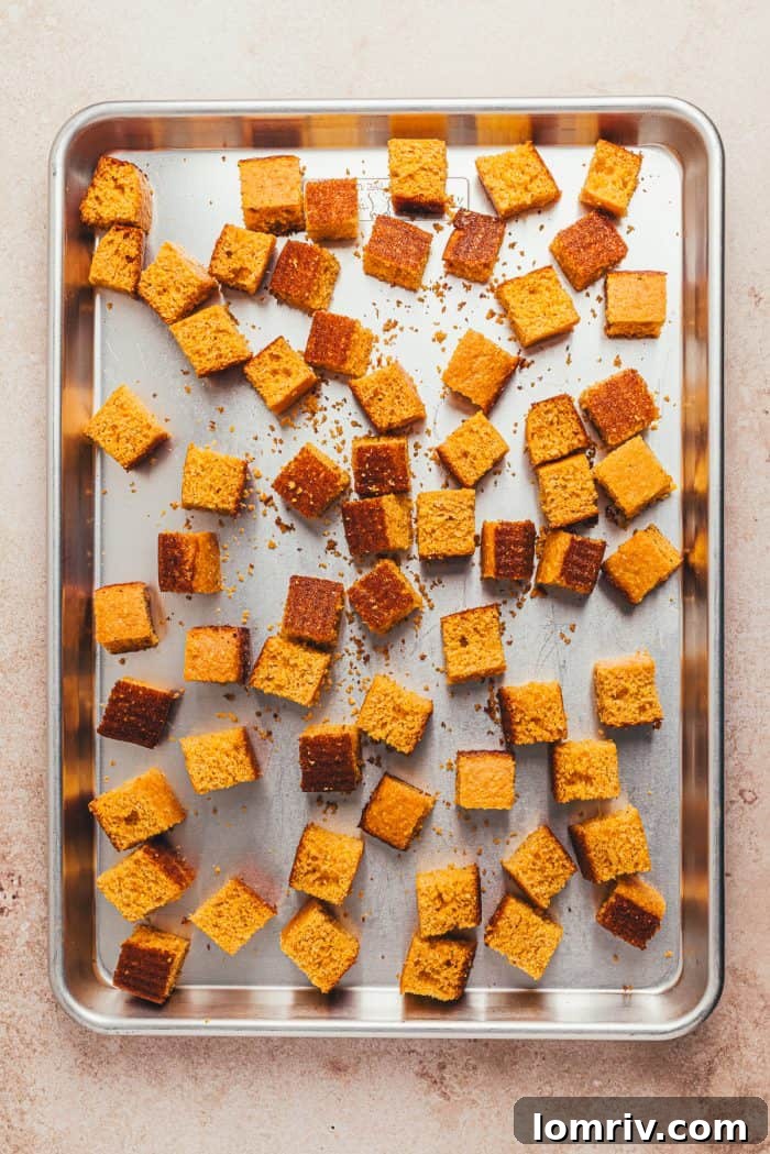Cornbread cubes on a baking sheet.