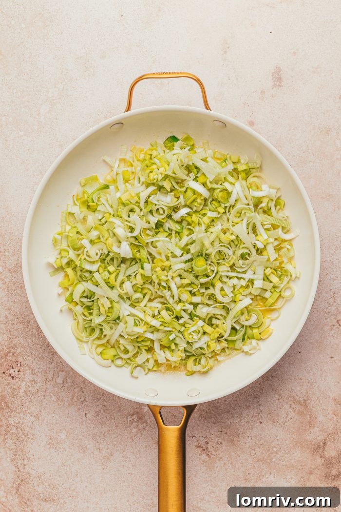 Sliced leeks in a skillet.
