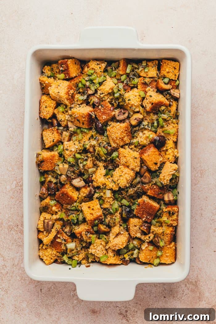 A white rectangle baking dish with unbaked stuffing.