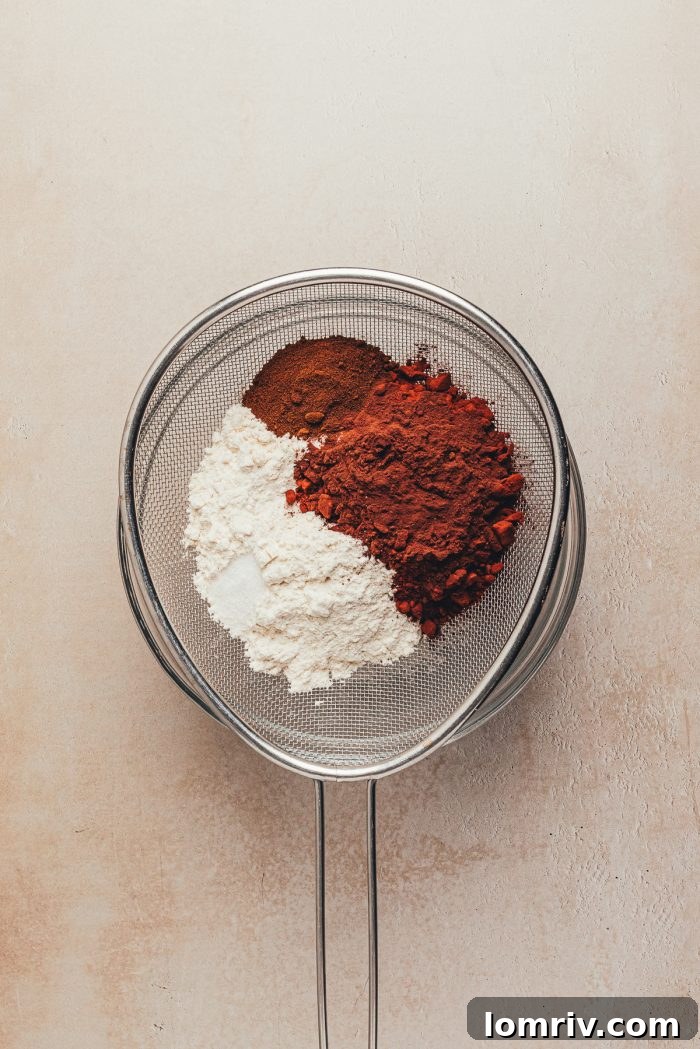 Dry ingredients—flour, cocoa, espresso powder, and salt—sifted and combined in a mixing bowl.