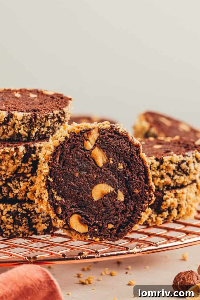 Several chocolate hazelnut shortbread cookies artfully arranged on a cooling rack.
