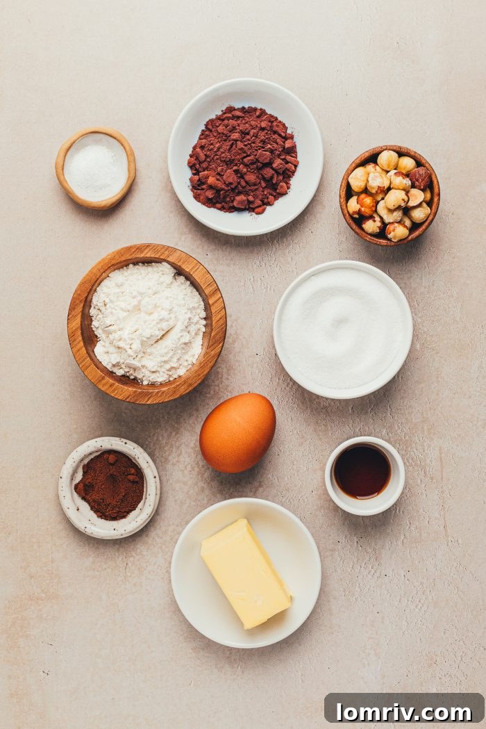 Various bowls holding the essential ingredients for making chocolate hazelnut slice and bake cookies.